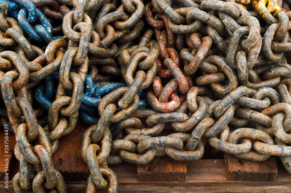 Anchor chain over an old pallet in the port. Anchor chain over an old pallet in the port.