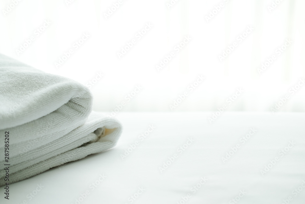 white towel on bed with see through curtain background. white towel on bed with see through curtain background.
