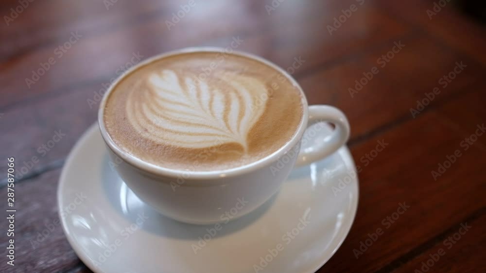 hot latte art coffee on wood table, relax time hot latte art coffee on wood table, relax time