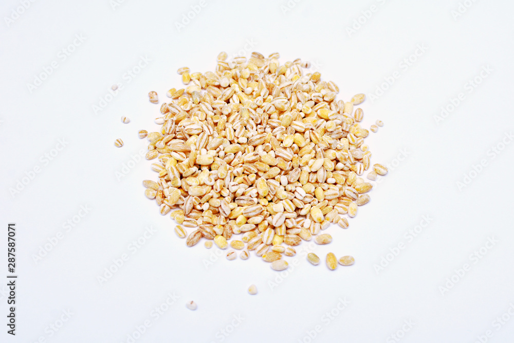 Barley heap surface close up macro isolated on white background. Organic healthy vegetarian food. Barley heap surface close up macro isolated on white background. Organic healthy vegetarian food.