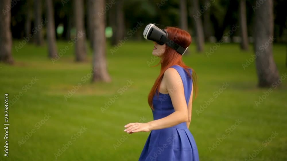 girl actively gesticulates with her hands while using virtual reality gadget girl actively gesticulates with her hands while using virtual reality gadget