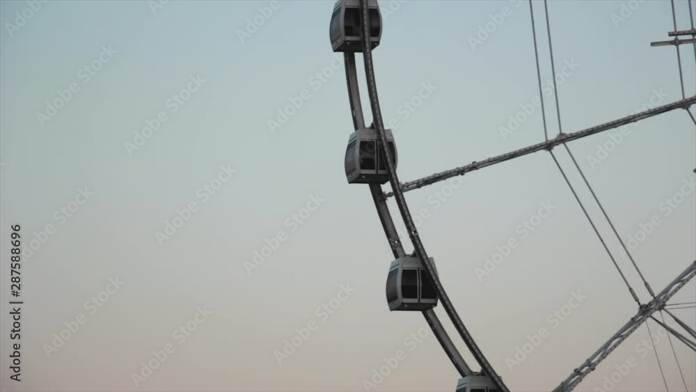 Ferris wheel rotates at sunset under a beautiful sky Ferris wheel rotates at sunset under a beautiful sky