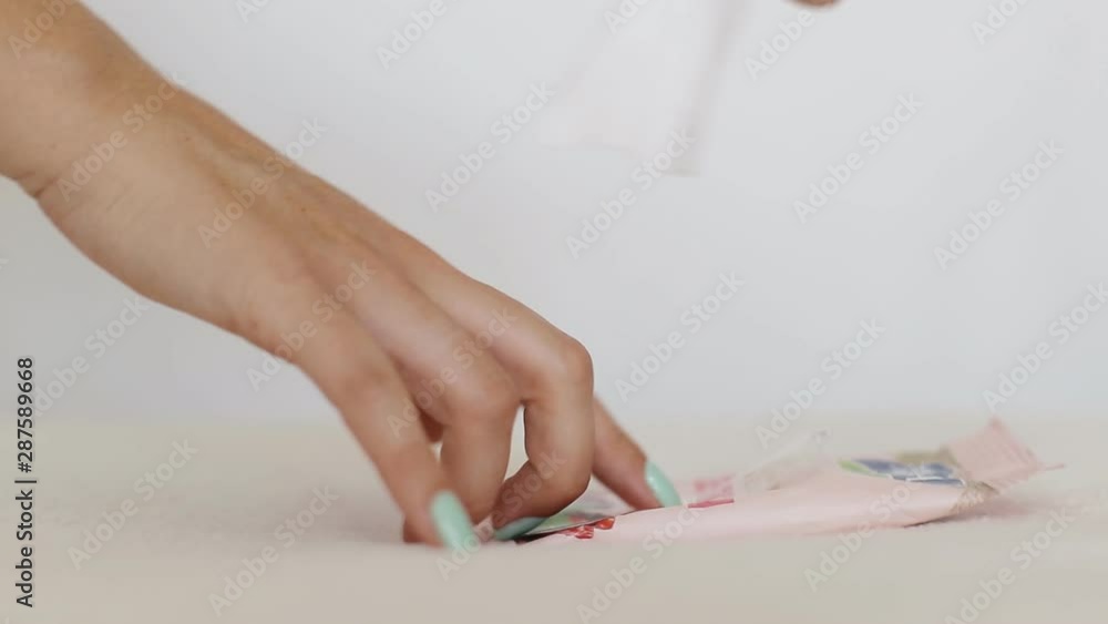 Girl takes a wet towel to clean her skin and cleans her hands, close-up Girl takes a wet towel to clean her skin and cleans her hands, close-up