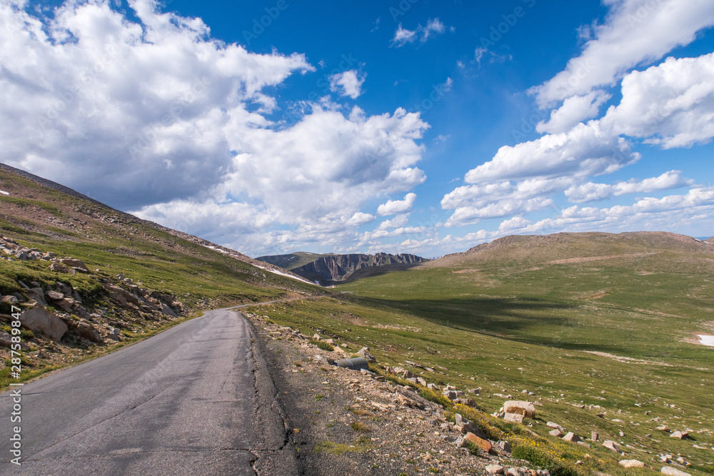 Alpine landscape of road and green mountain tops leading to Mount Evans in Colorado