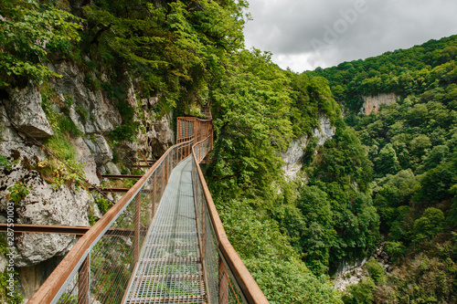 Okatse Canyon in Georgia. Waterfall on the cliffs of the reserve. Beautiful natural canyon  hiking trail over the canyon  overlooking the mountain river  near Kutaisi.