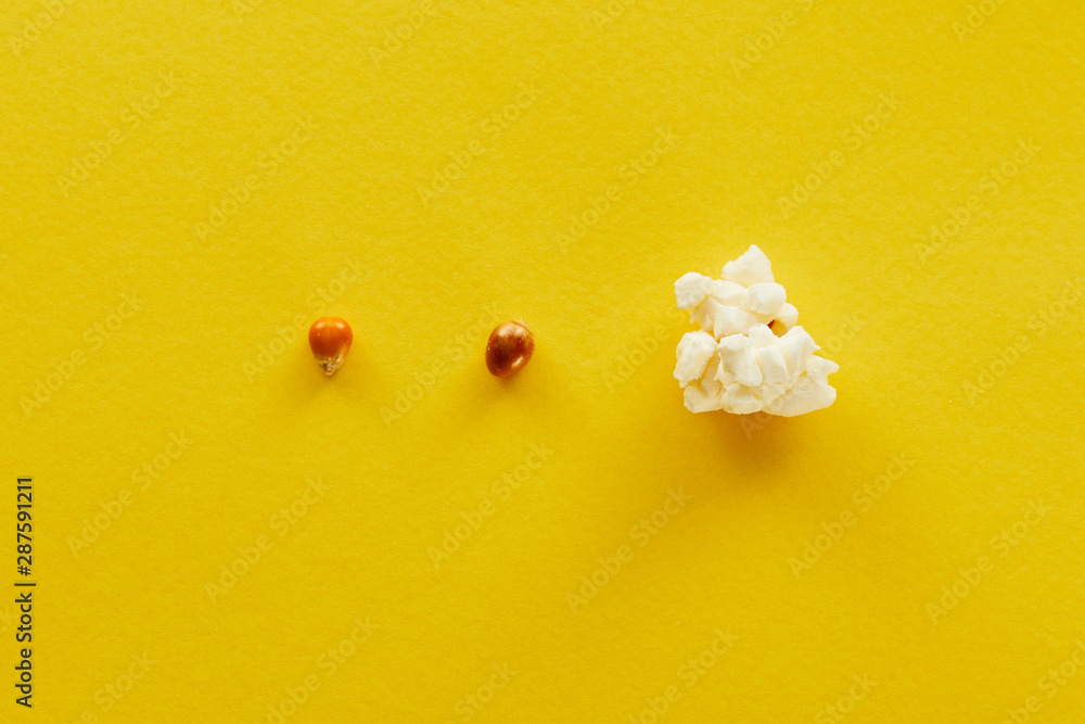 top view of delicious popcorn and corn on yellow background top view of delicious popcorn and corn on yellow background