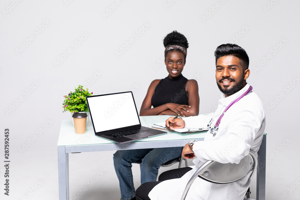 African patient having consultation with doctor in office African patient having consultation with doctor in office