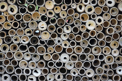 A pile of Chinese bamboo tubes background. © Tommy