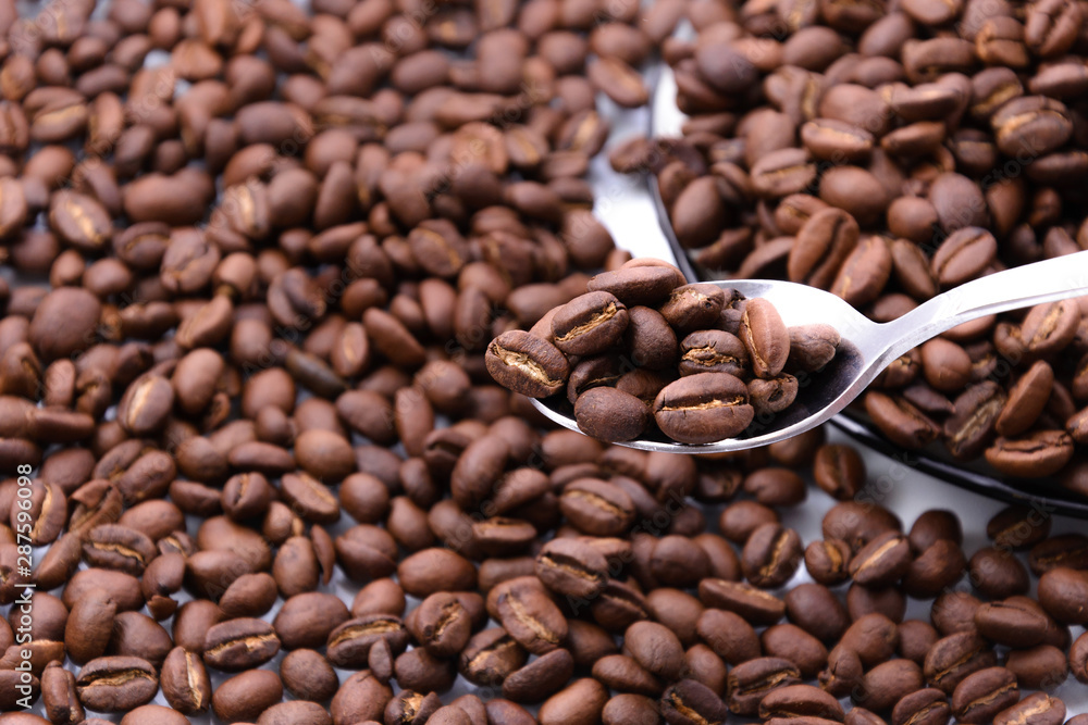 roasted coffee beans in spoon roasted coffee beans in spoon