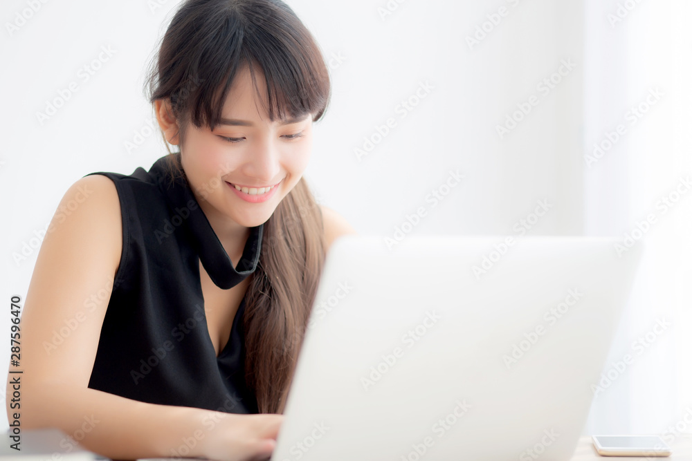 Beautiful young freelance asian woman working and typing on laptop computer at desk office with professional, girl using notebook checking email or social network, business and lifestyle concept. Beautiful young freelance asian woman working and typing on laptop computer at desk office with professional, girl using notebook checking email or social network, business and lifestyle concept.