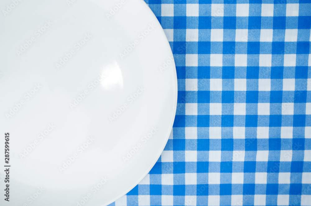 Blank white plate or dish on dinner table with copy space