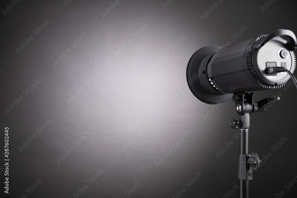 Professional flash pulsed light directed to the black wall.