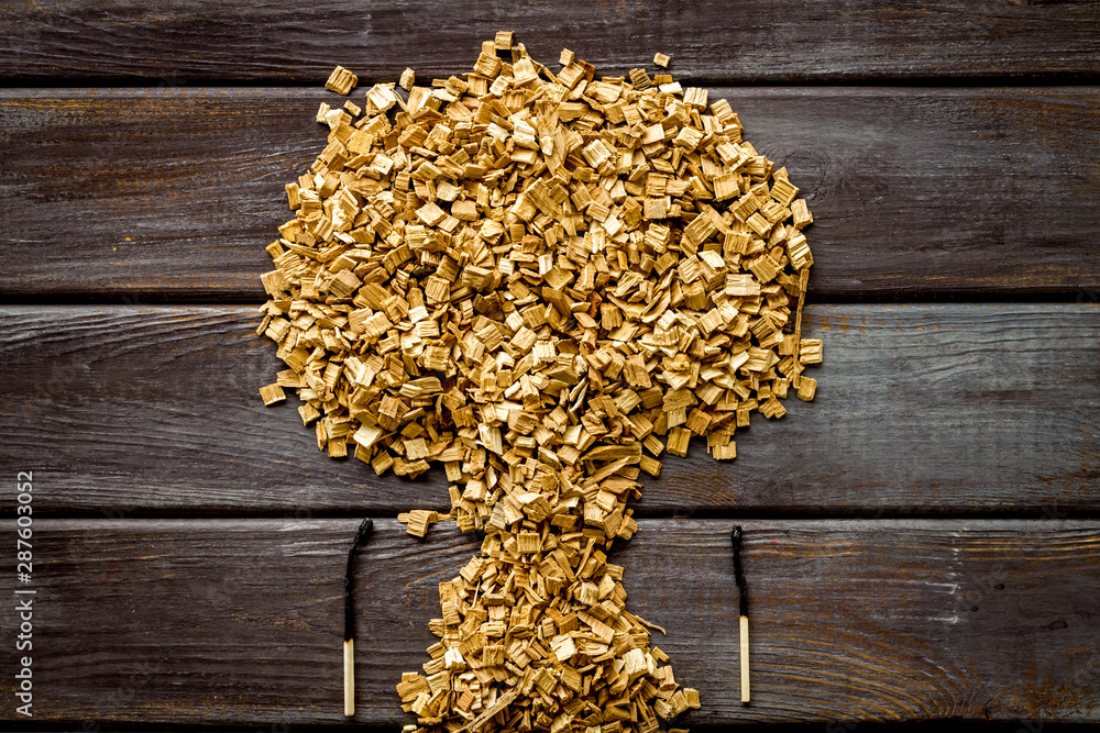 Symbol of fire in woods with tree from kindling and matches on wooden background top view