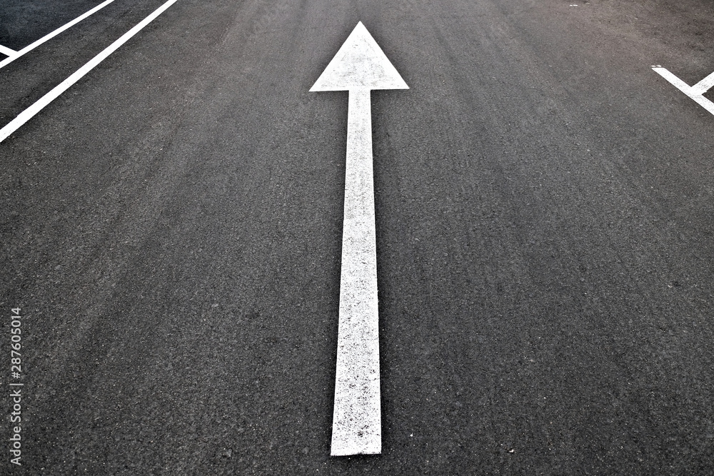 Long white arrow pointing up on black background, angled perspective. Long white arrow pointing up on black background, angled perspective.