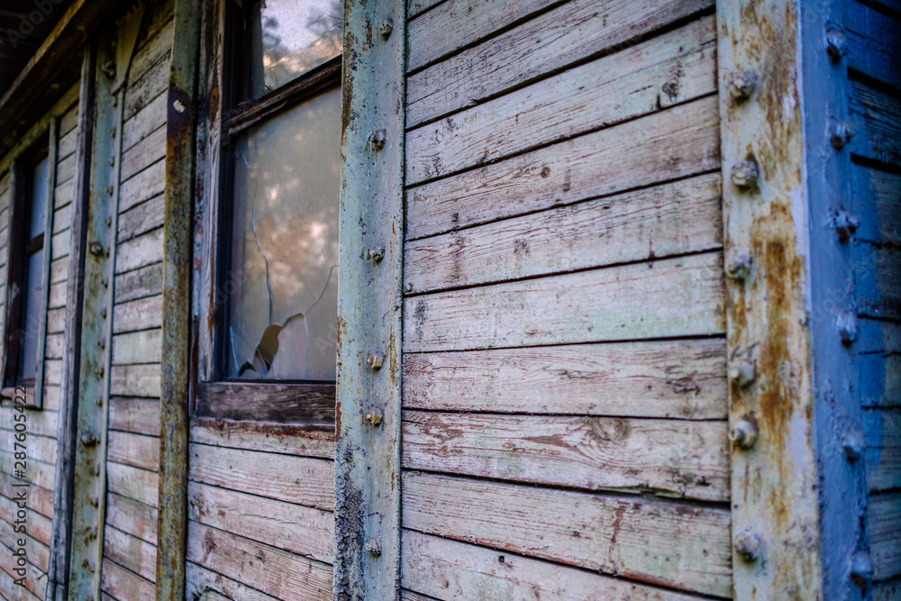 part of a wooden wall with broken Windows