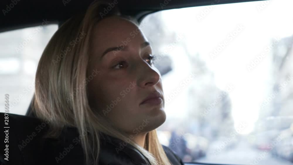 Young, pensive woman in car, slow motion 240fps Young, pensive woman in car, slow motion 240fps
