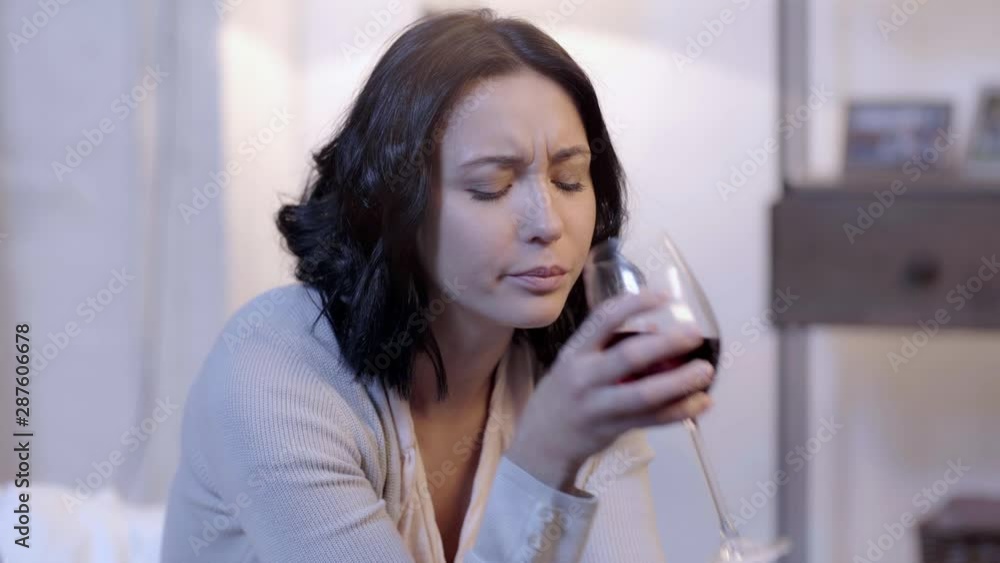 upset and attractive woman drinking wine upset and attractive woman drinking wine