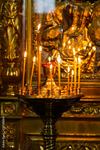 Large church candlestick with burning candles in orthodox church