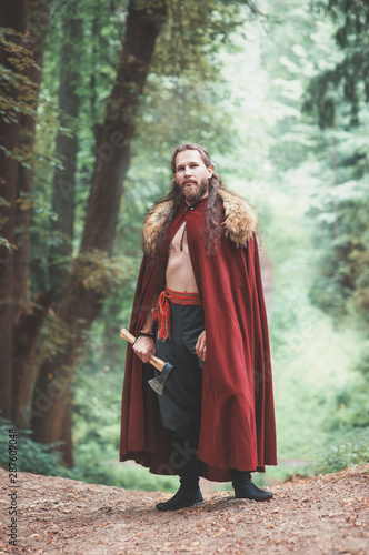 Warrior Viking man with iron axe standing