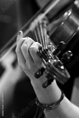 The hand of a girl playing the violin in black and white tones