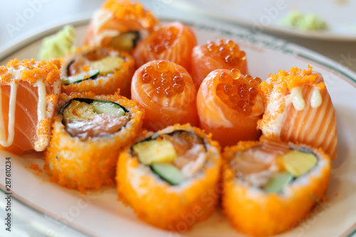 Close-up orange color Salmon Sushi on White Plate.