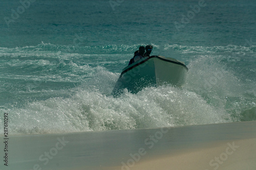 migrant boat landing on the beach