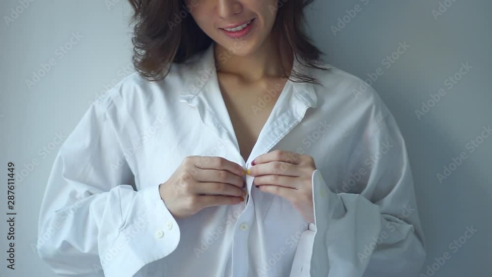 Attractive Women take off the white shirt Show bra and breast. low light  Stock Video | Adobe Stock