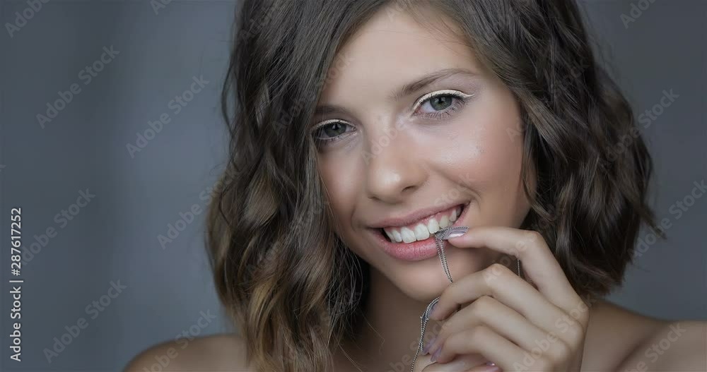 Attractive young girl with NailArt . beautiful girl with perfect skin and amazing manicure with decorations. Attractive young girl with NailArt . beautiful girl with perfect skin and amazing manicure with decorations.