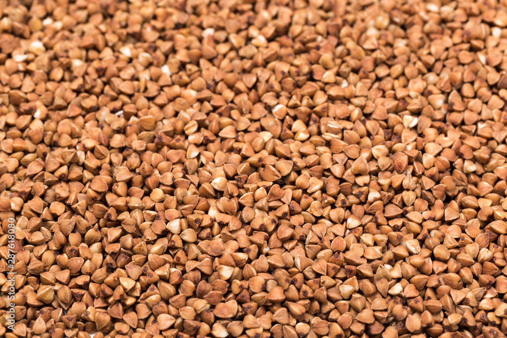 Macro Photo food buckwheat groats. Texture background grain buckwheat groats. Image food product porridge buckwheat grains Macro Photo food buckwheat groats. Texture background grain buckwheat groats. Image food product porridge buckwheat grains