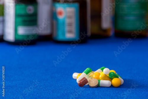 Medical pills. Color capsules medication. Blue background. Health care concept. Free space for text. Medicines. Many different pills. Chemical industry.