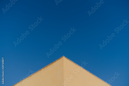 detail of a yellow corner over blue sky background. Architecture concept. Abstract