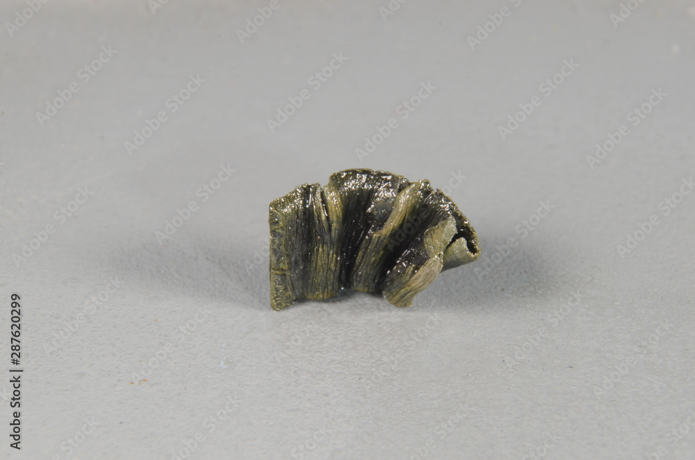 Closeup on a piece of the lanthanide element Europium (Eu). This element needs to be covered with a thin layer of oil to prevent reaction with oxygen in the air. Closeup on a piece of the lanthanide element Europium (Eu). This element needs to be covered with a thin layer of oil to prevent reaction with oxygen in the air.