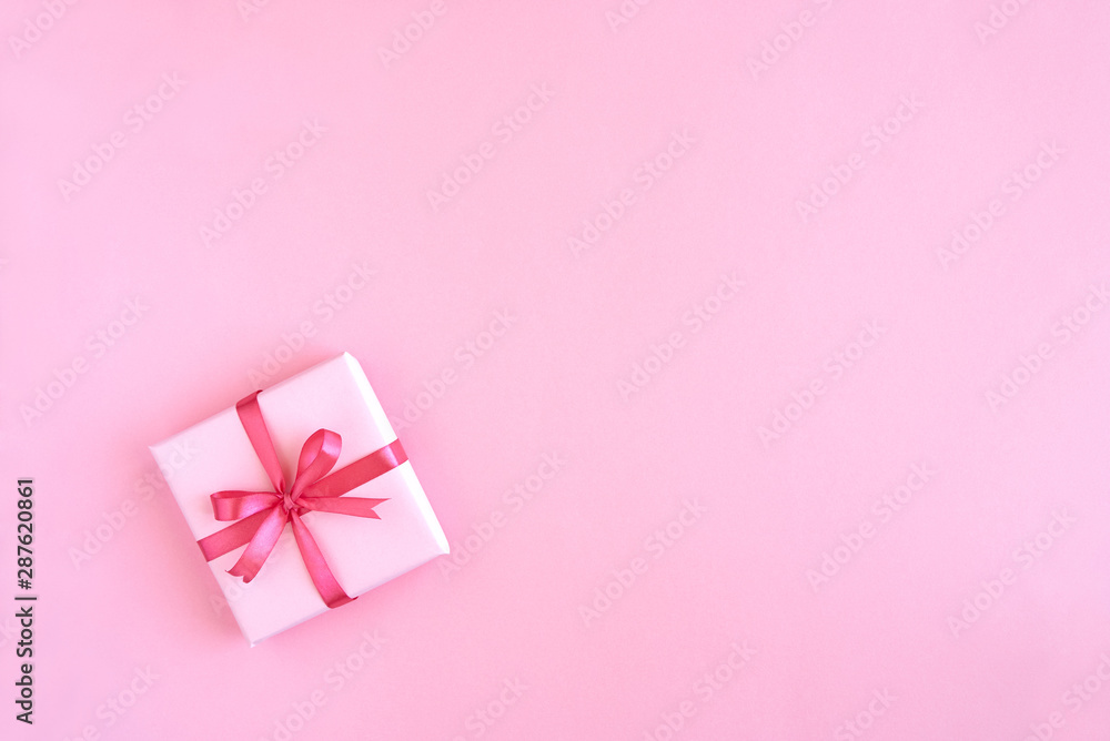 Gift box with ribbon and bow on color background and space for text. Top view Gift box with ribbon and bow on color background and space for text. Top view