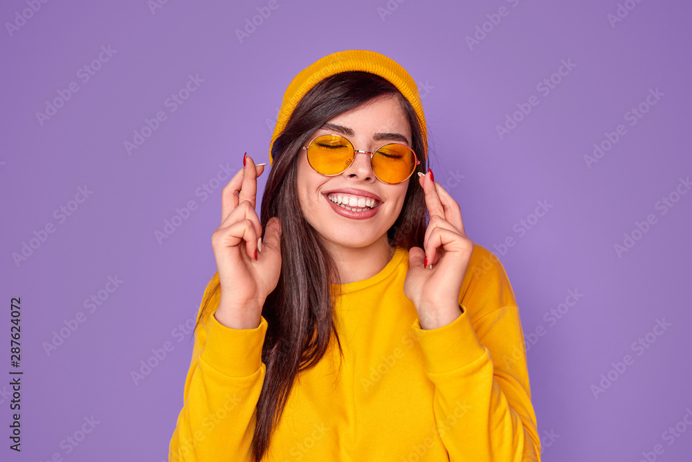 Joyful trendy woman crossing fingers with hope Joyful trendy woman crossing fingers with hope