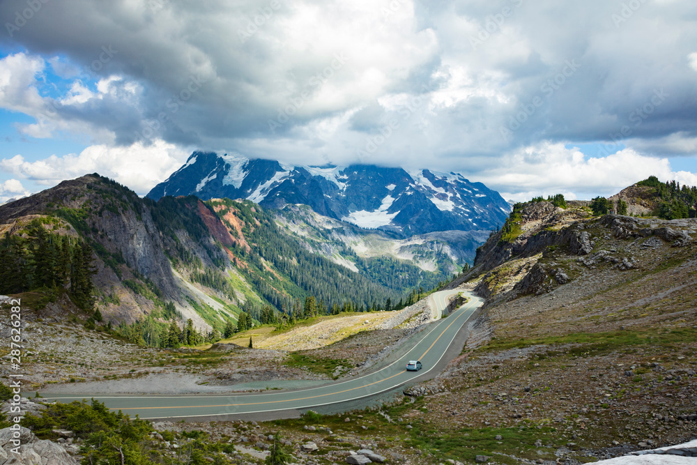 View of Cascade mountains and car traveling down Mount Baker Highway