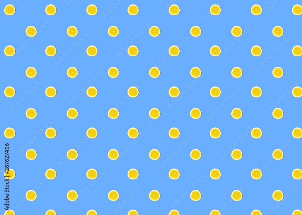 Seamless pattern of fresh lemon round cut on blue