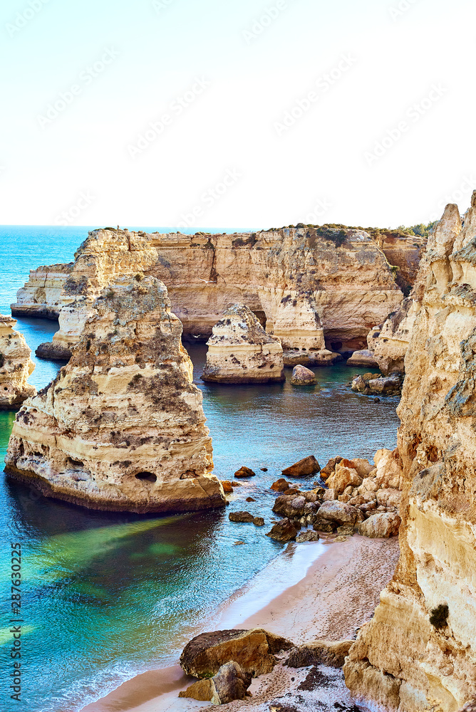 Rocks and sandy beach in Portugal, Atlantic coast, Algarve.