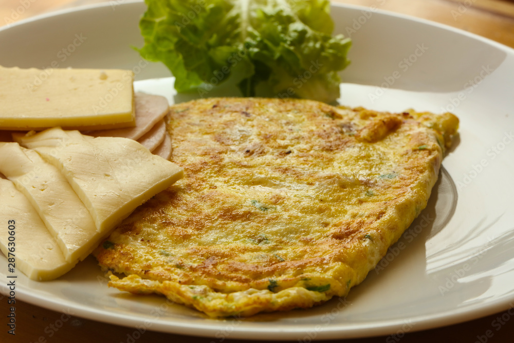 Omelet with cheese and salad