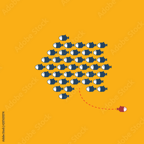 Think differently -One red unique different fish swimming opposite way of identical blue ones.