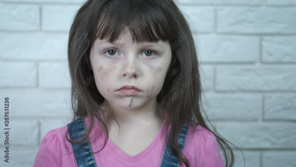 Dirty offended child. Offended dirty little girl looks at the camera. Dirty offended child. Offended dirty little girl looks at the camera.