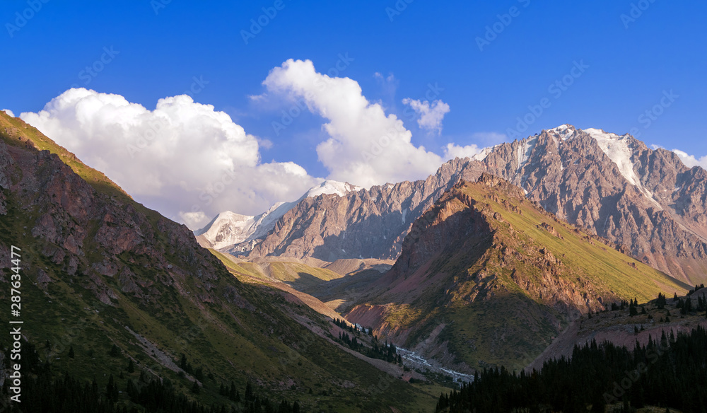 Panoramic view of the beautiful Left Talgar mountain valley with river, rocks and forest in Tian Shan mountains near Almaty city; best place for active lifestyle, hiking and trekking in Kazakhstan
