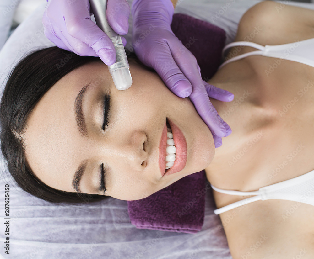 Cute Korean woman gets a face peeling procedure in a beauty salon. Skin care