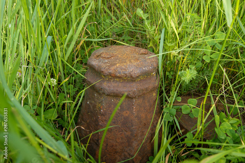 old rusty kettlebell stands in the grass