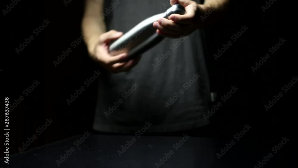 Young guy change plastic to steel bottle, on black background. Young guy change plastic to steel bottle, on black background.