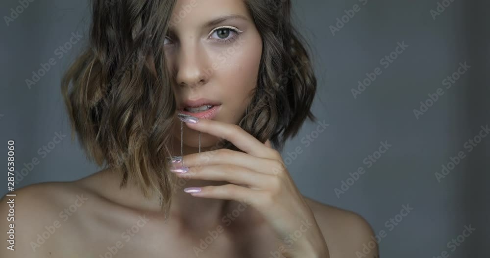 Attractive young girl with NailArt . beautiful girl with perfect skin and amazing manicure with decorations. Attractive young girl with NailArt . beautiful girl with perfect skin and amazing manicure with decorations.
