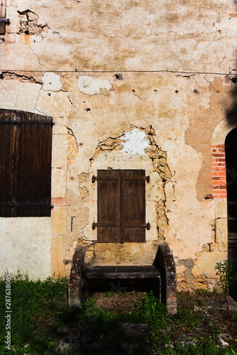 old door in the wall of an old house in south-west France