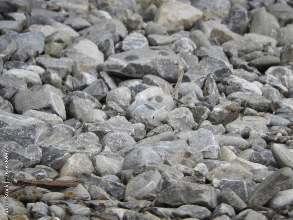 Gray gravel stones on the ground, country road Gray gravel stones on the ground, country road