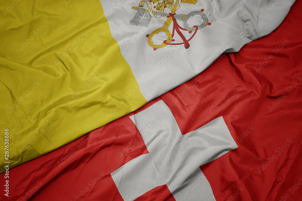 waving colorful flag of switzerland and national flag of vatican city. waving colorful flag of switzerland and national flag of vatican city.