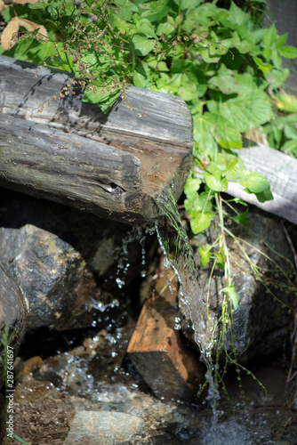 Wallpaper Mural Wooden gutter for water. Mountain water supply to the mill. Spring with clear mountain water. Torontodigital.ca