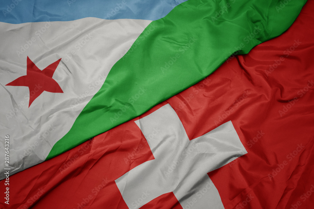 waving colorful flag of switzerland and national flag of djibouti.
